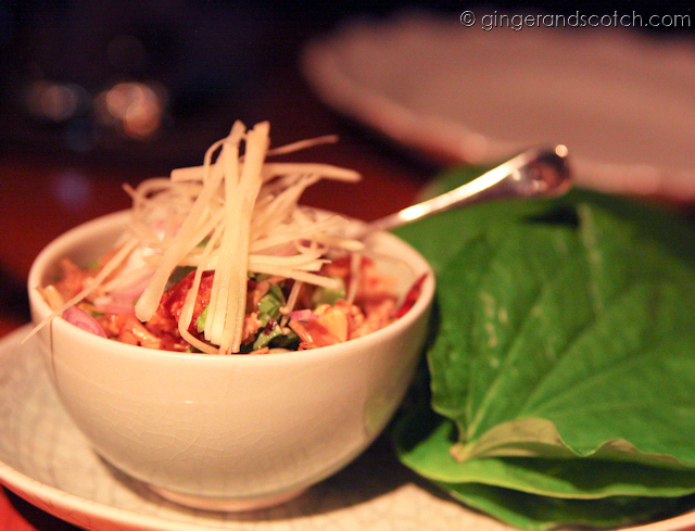 spicy pork with mint, peanuts and crunchy rice on betel leaves spicy pork with mint, peanuts and crunchy rice on betel leaves
