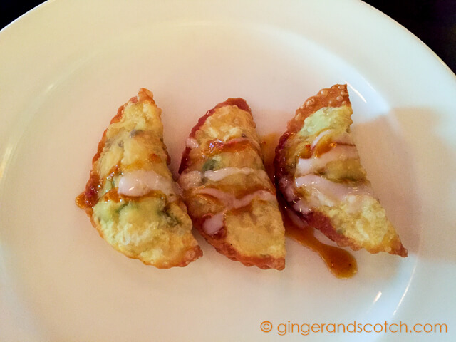 Tempura Canadian lobster ravioloi with dried scallops and shitake mushrooms; served with baby rocket leaves and coconut mango sauce