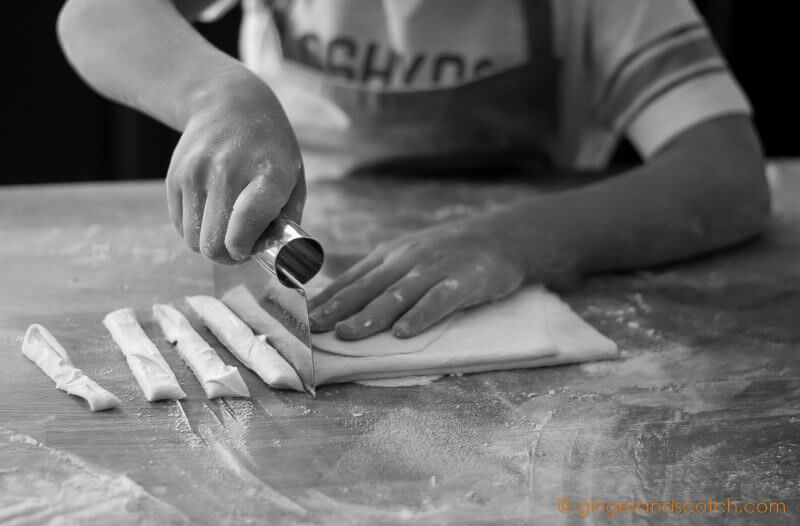 My son safely cutting homemade Chinese Noodles