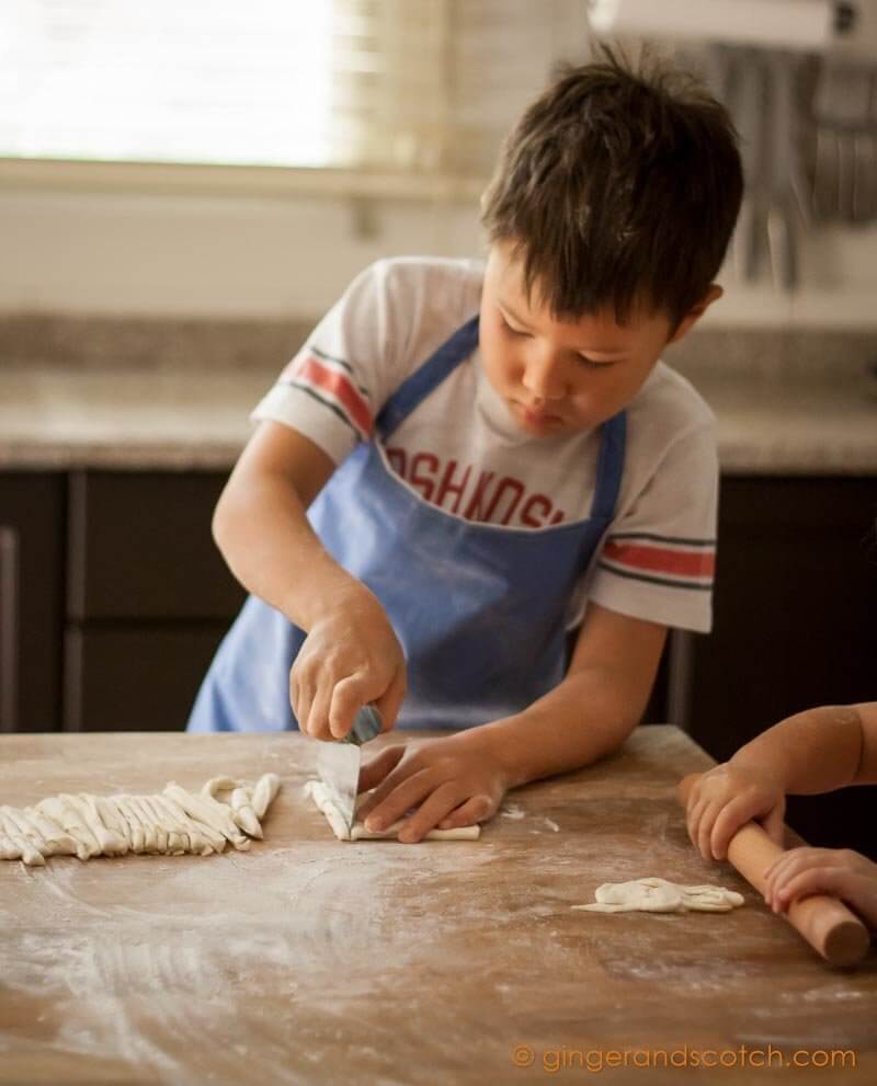 My son safely cutting homemade Chinese noodles