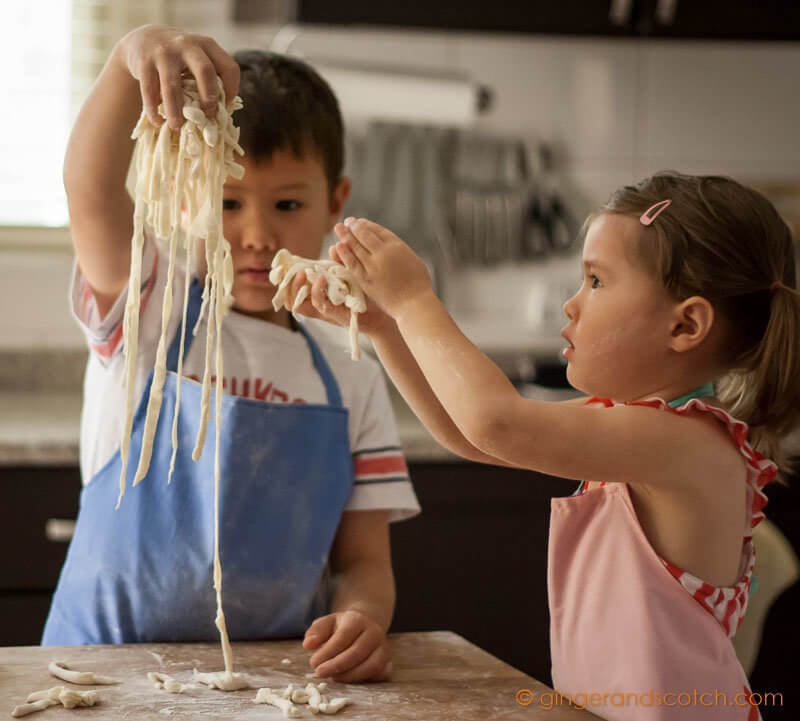 Kids fluffing strands of making homemade Chinese