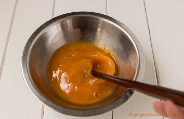 Mixing the eggs with the alkaline water for homemade Chinese egg noodles from scratch